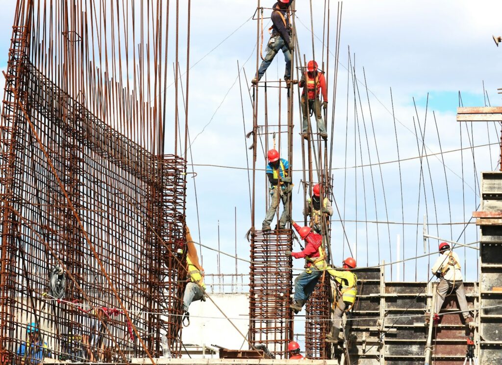 Construction workers erecting a metal building.