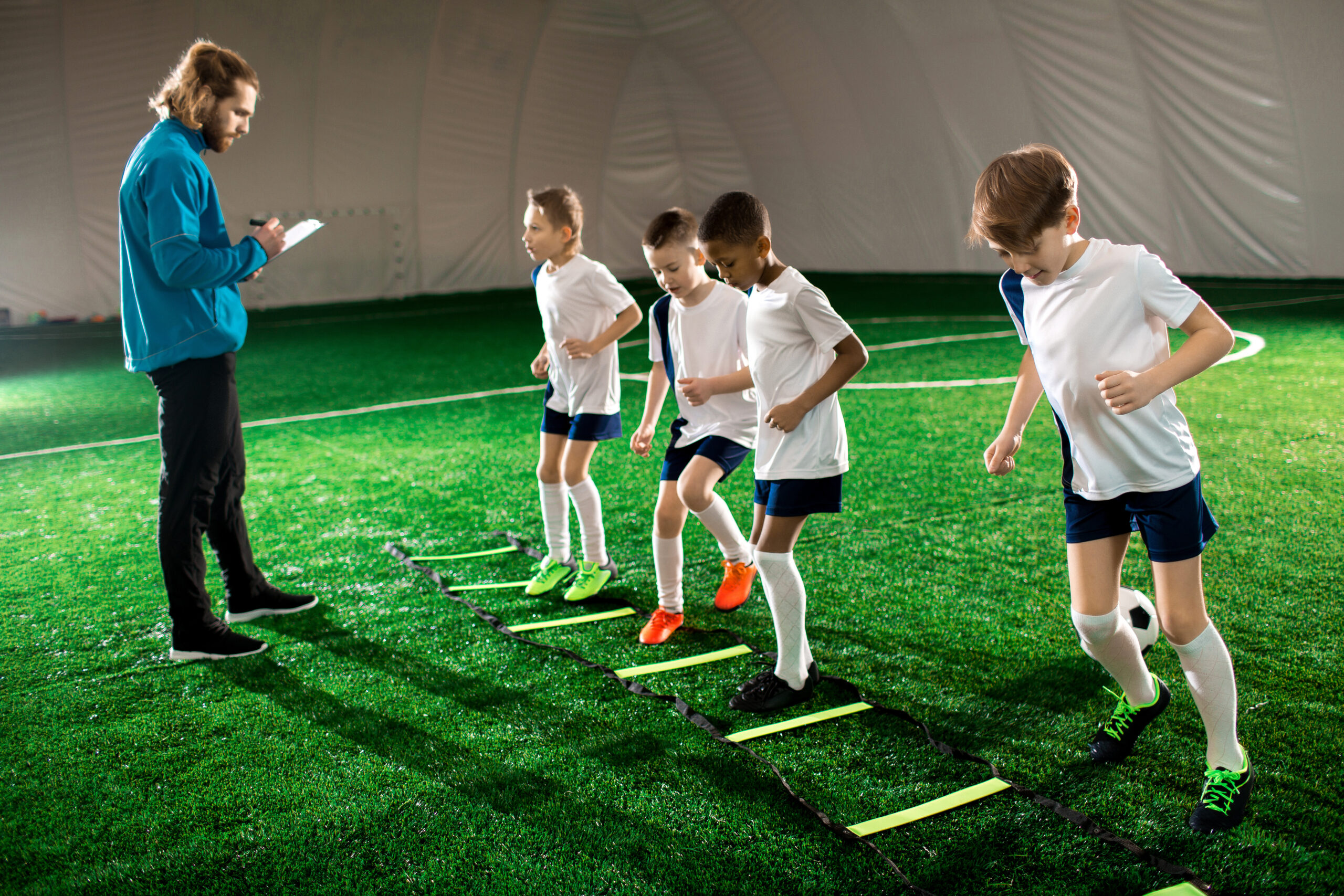 Teenage soccer players using an Indoor soccer facility for training