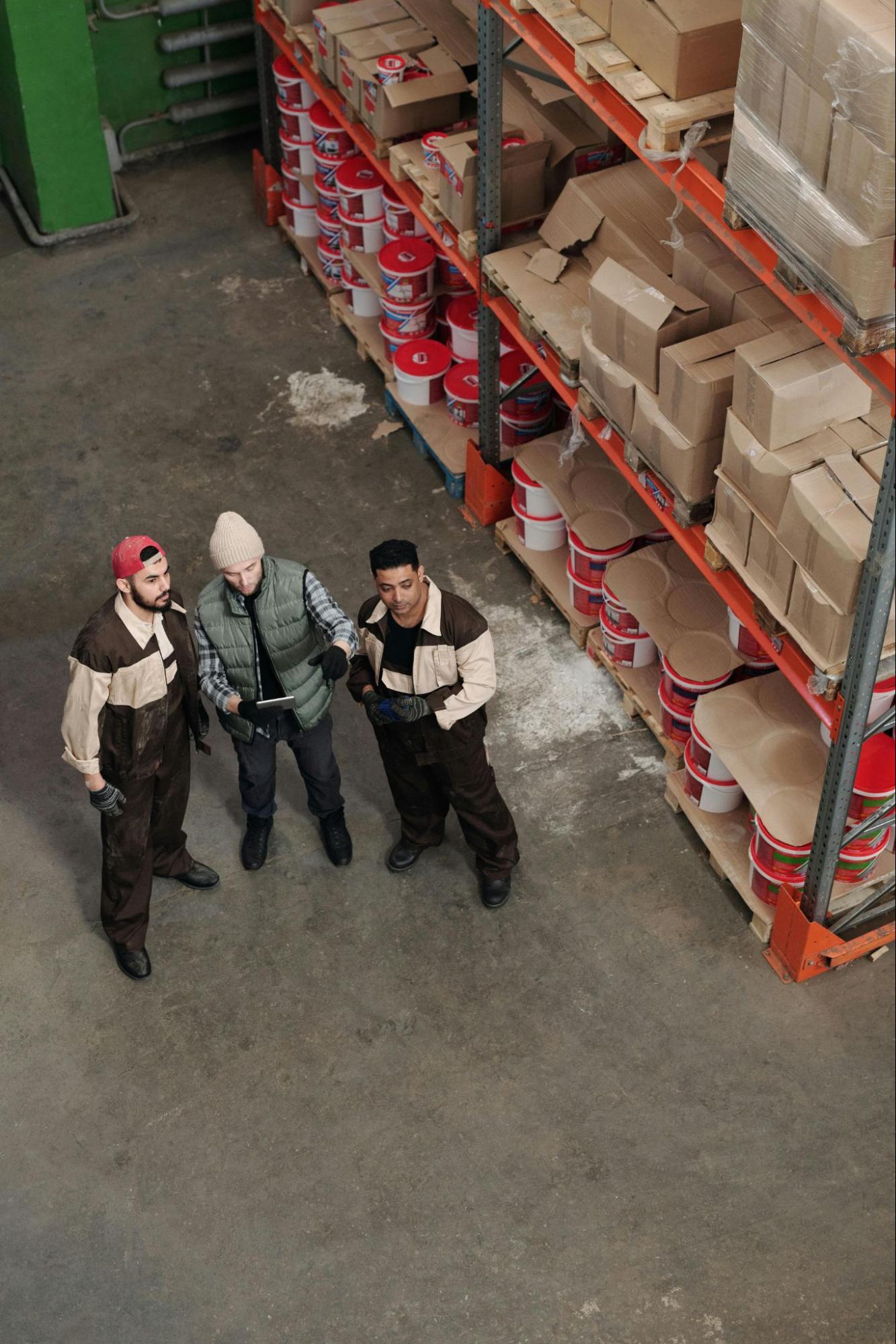 Three men working in a distribution center. 
